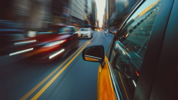 Cars passing each other in New York City to arrive on time